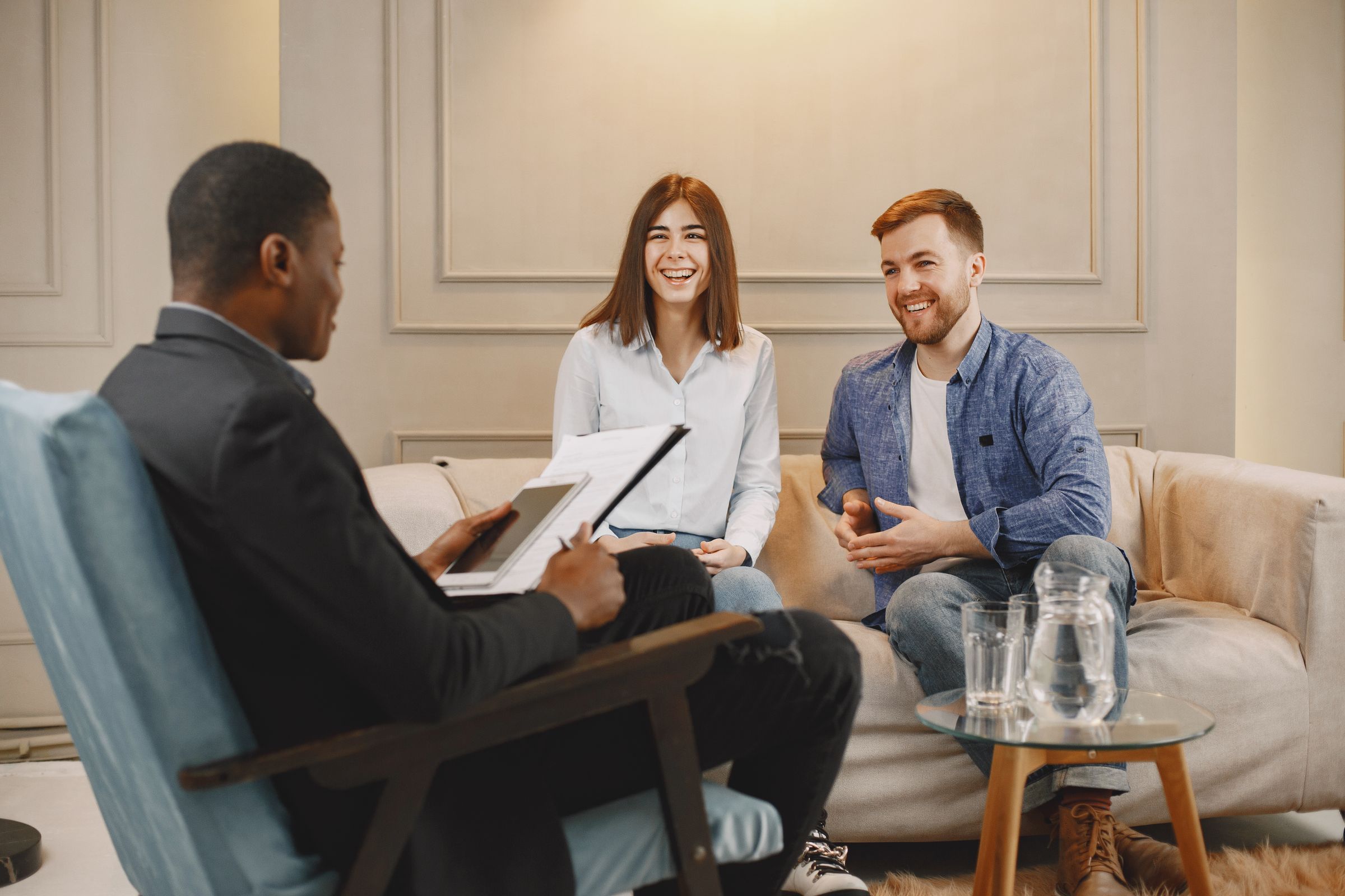 A peer specialist meeting with parents in their living room
