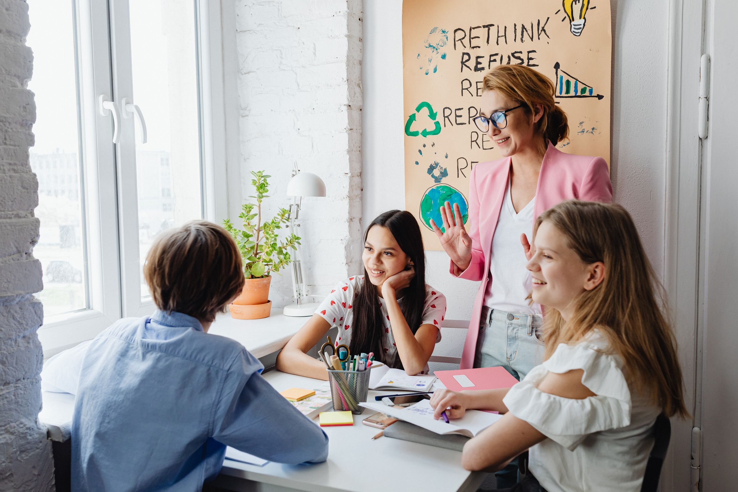 A therapist leading a small group session with teenagers indoors