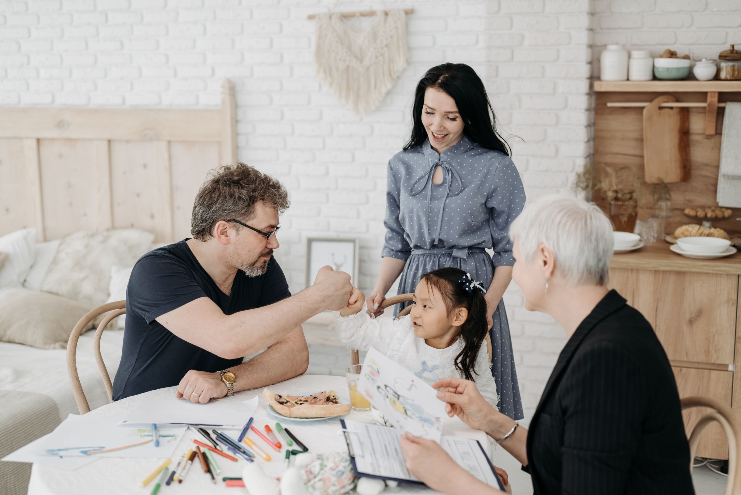 A professional talking with parents while their child sits with them