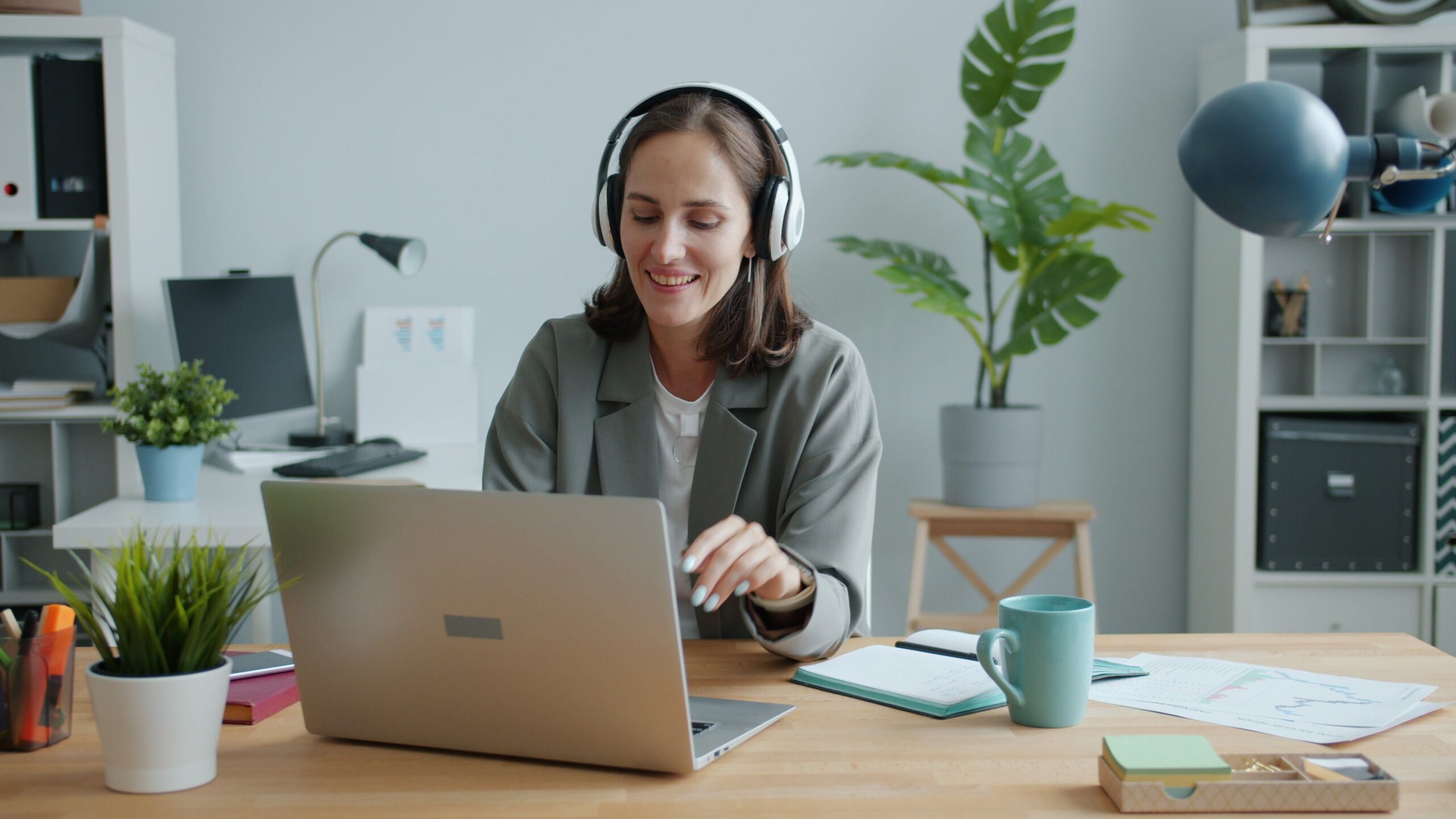 A therapist on a video call with a client from a bright, quiet office